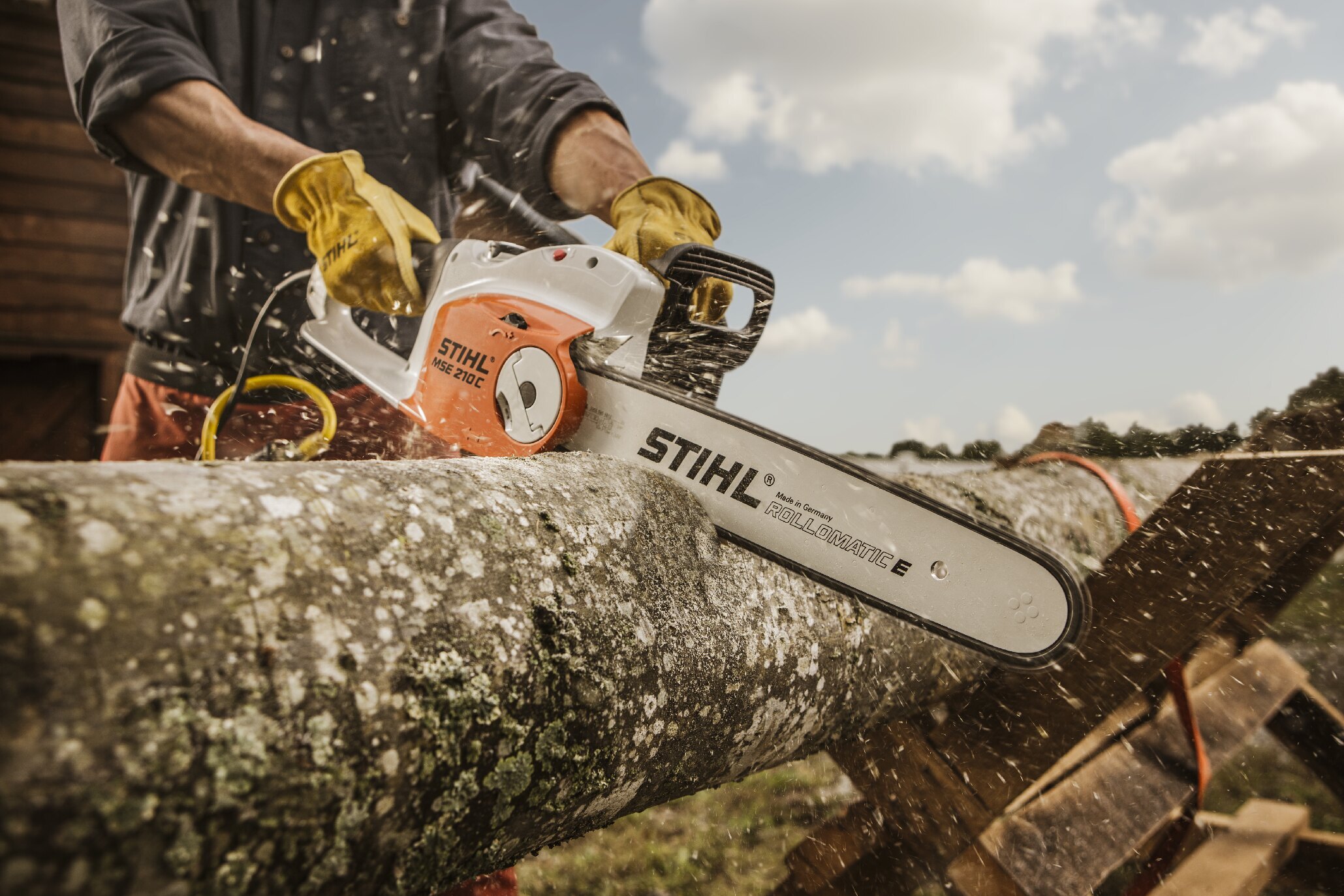 STIHL chainsaw cutting through a log